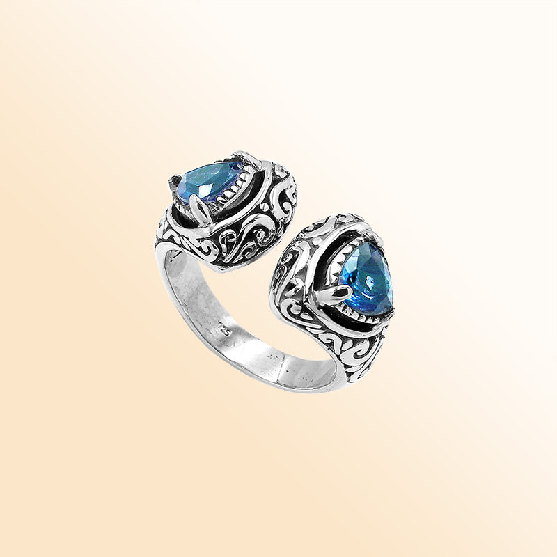Sterling silver Bali scrollwork ring with trillion-cut Blue Topaz Quartz – artisan handcrafted statement jewelry for women.