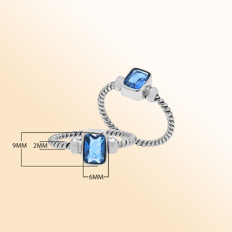 Handcrafted sterling silver twisted band ring with rectangular-cut Blue Topaz Quartz, artisan unisex jewelry for everyday wear or gifting.