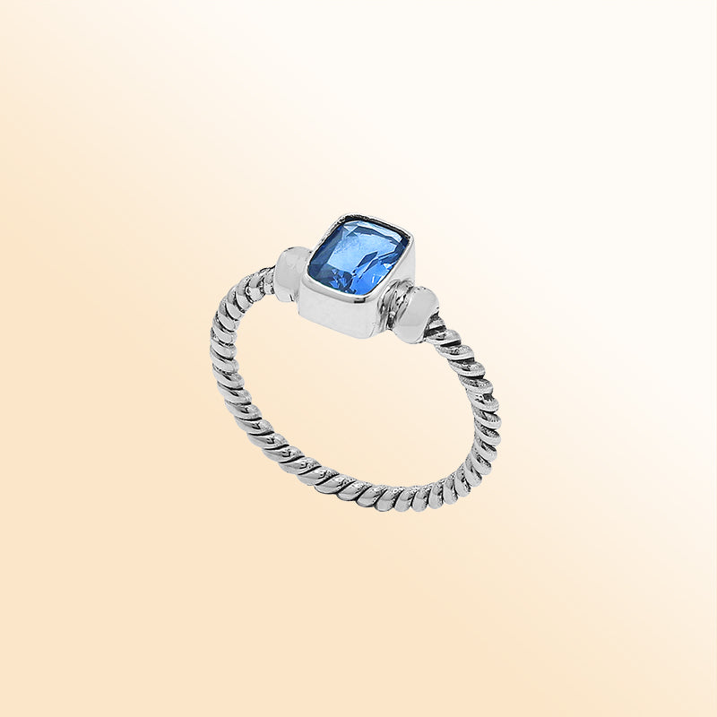 Handcrafted sterling silver twisted band ring with rectangular-cut Blue Topaz Quartz, artisan unisex jewelry for everyday wear or gifting.
