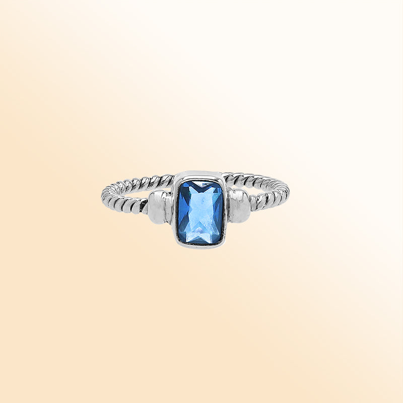 Handcrafted sterling silver twisted band ring with rectangular-cut Blue Topaz Quartz, artisan unisex jewelry for everyday wear or gifting.