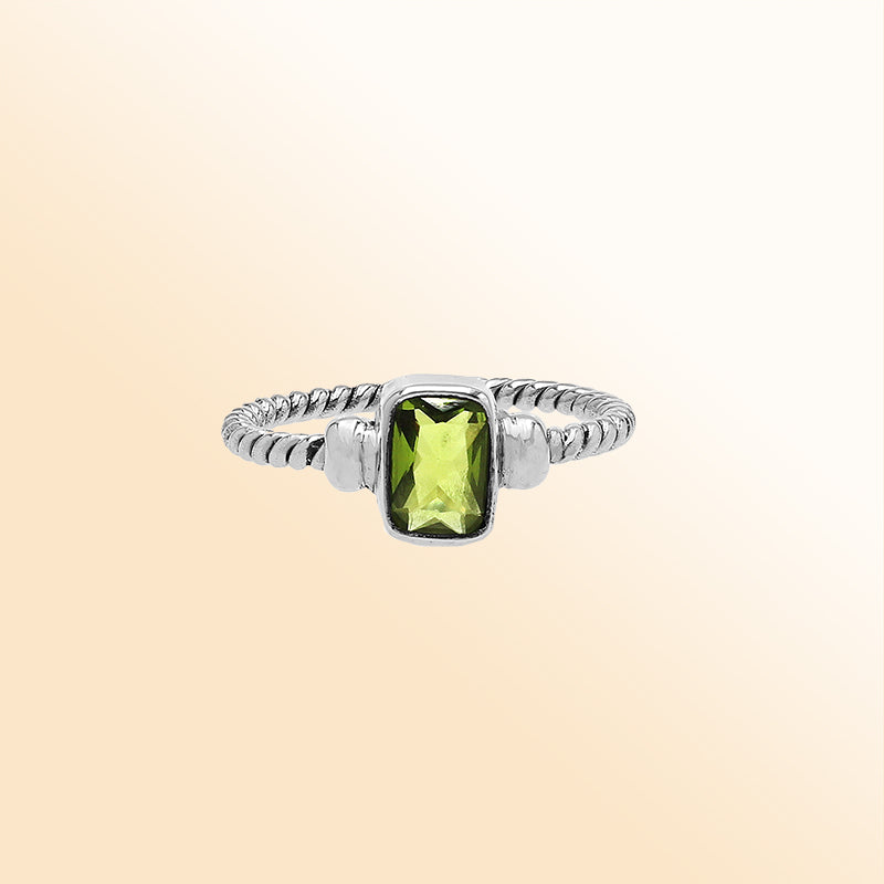 Handcrafted sterling silver twisted band ring with rectangular-cut Peridot Quartz, artisan unisex jewelry for everyday wear or gifting.