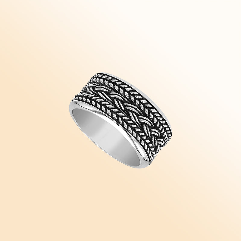 Handcrafted sterling silver wide band ring with intricate braided Bali-inspired design and oxidized finish, unisex artisan jewelry for everyday wear or gifting.