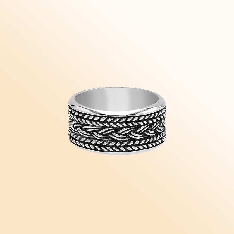 Handcrafted sterling silver wide band ring with intricate braided Bali-inspired design and oxidized finish, unisex artisan jewelry for everyday wear or gifting.
