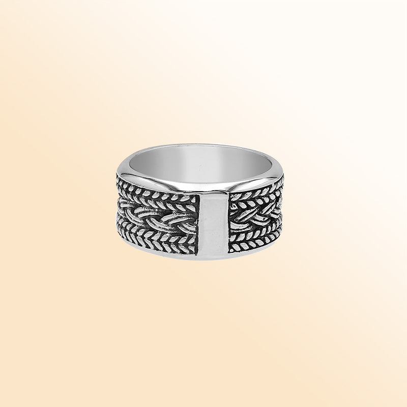 Handcrafted sterling silver wide band ring with intricate braided Bali-inspired design and oxidized finish, unisex artisan jewelry for everyday wear or gifting.