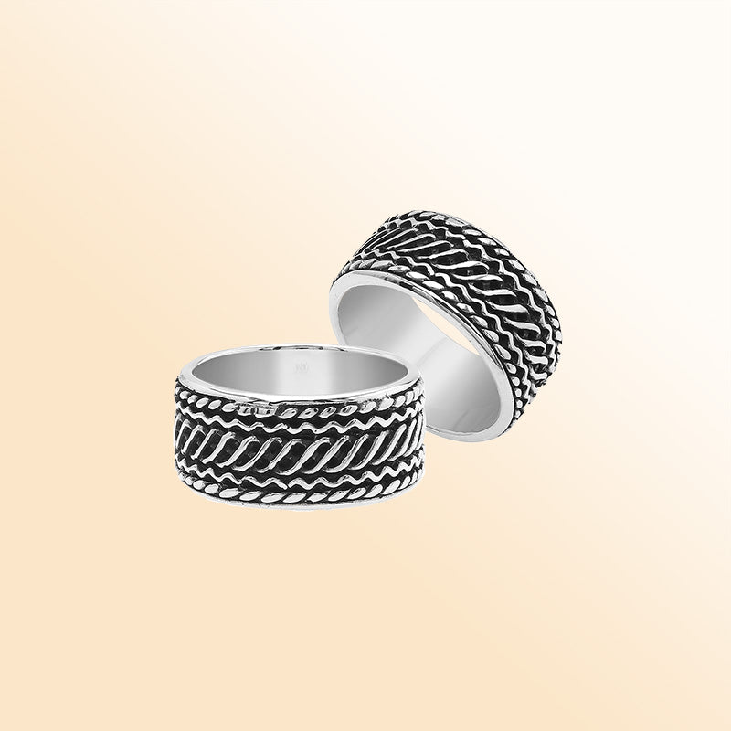 Handcrafted sterling silver wide band ring with diagonal braided Bali-inspired design and oxidized finish, unisex artisan jewelry for everyday wear or gifting.