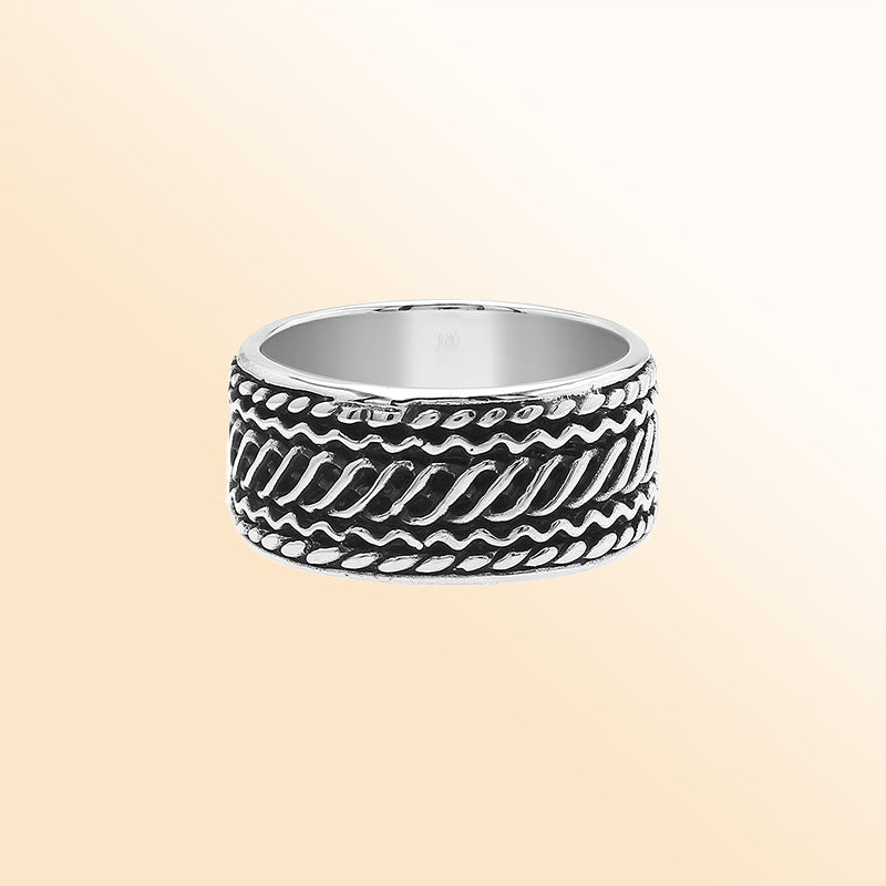 Handcrafted sterling silver wide band ring with diagonal braided Bali-inspired design and oxidized finish, unisex artisan jewelry for everyday wear or gifting.