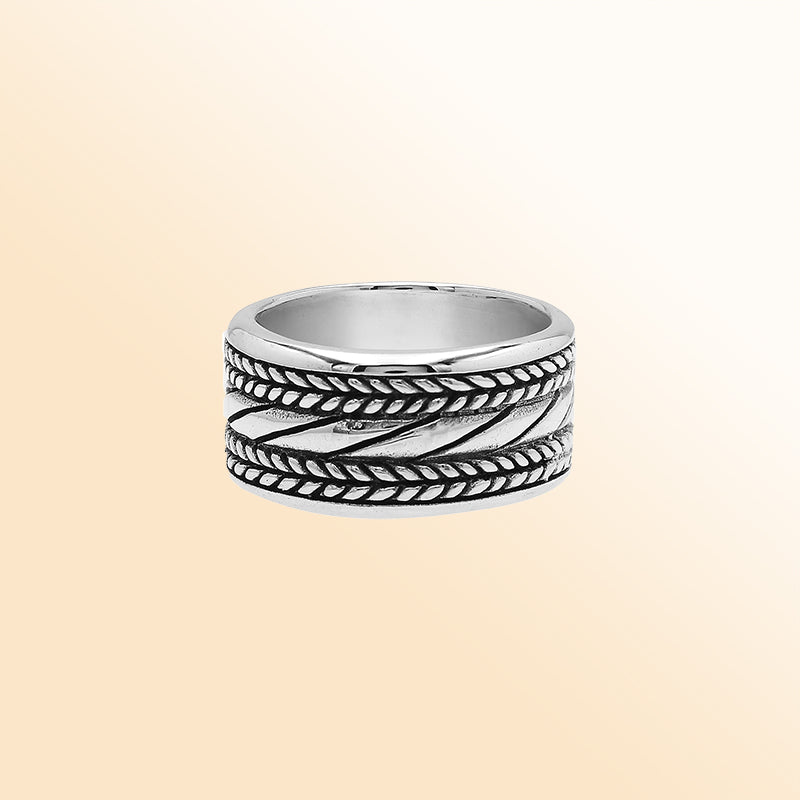 Handcrafted sterling silver wide band ring with diagonal rope Bali-inspired design and oxidized finish, unisex artisan jewelry for everyday wear or gifting.