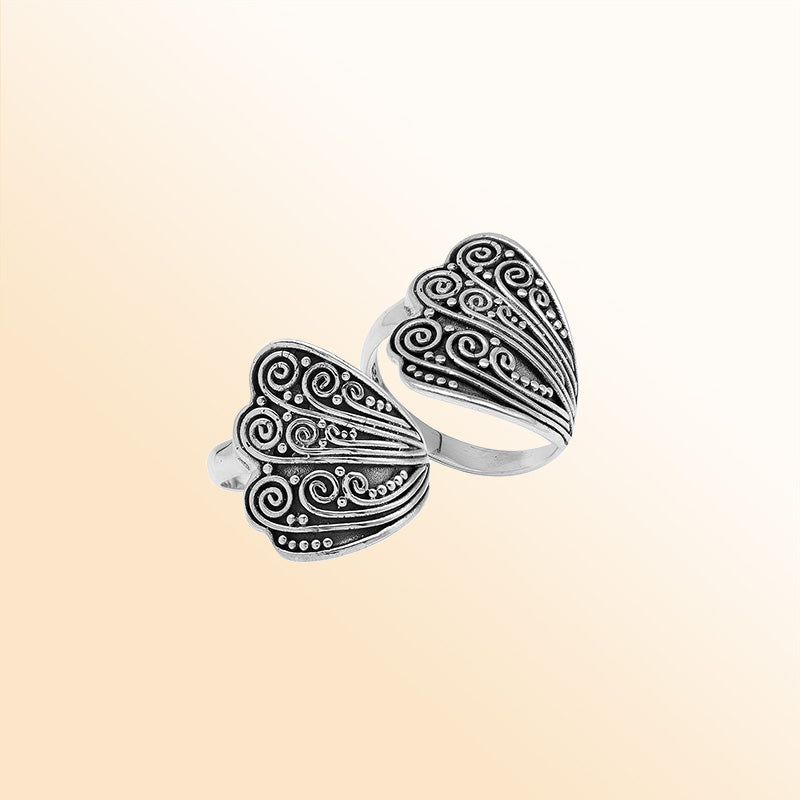 Sterling silver adjustable ring with elegant Balinese swirl and dot design, handcrafted artisan jewelry for everyday style.