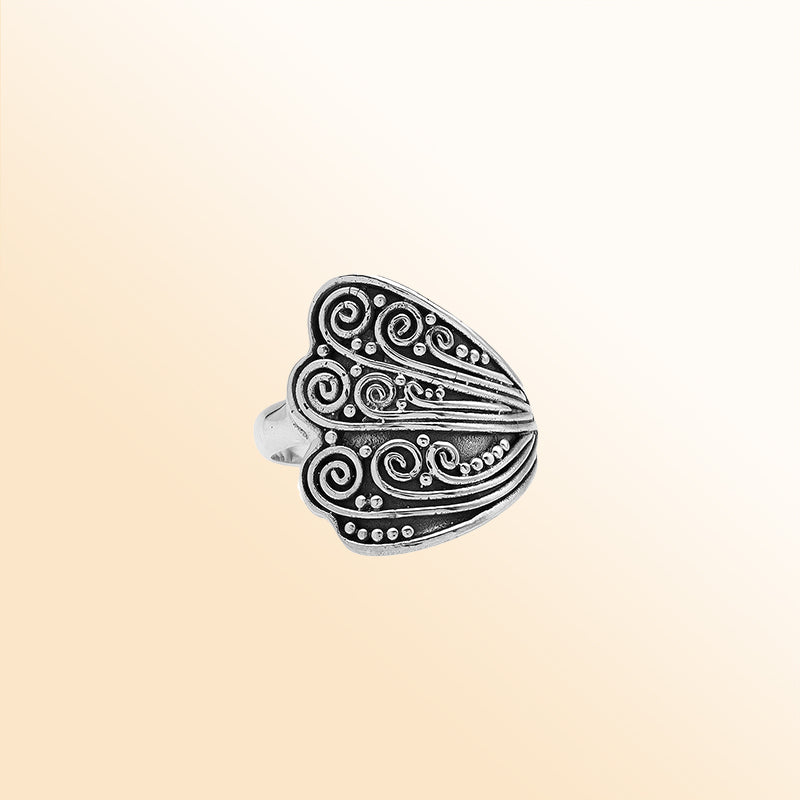 Sterling silver adjustable ring with elegant Balinese swirl and dot design, handcrafted artisan jewelry for everyday style.