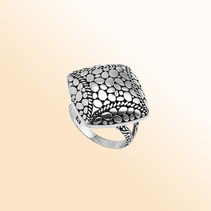 Sterling silver cushion dome ring with intricate Balinese dot design, handcrafted artisan statement jewelry.
