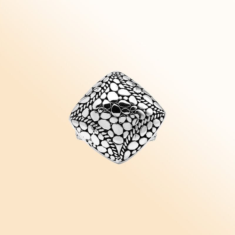Sterling silver cushion dome ring with intricate Balinese dot design, handcrafted artisan statement jewelry.
