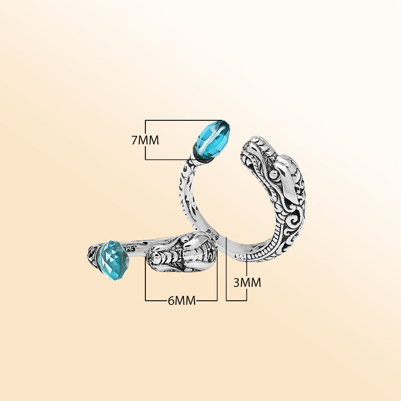 Handcrafted sterling silver dragon bypass ring with sparkling Blue Topaz Quartz, unique Bali artisan jewelry gift.