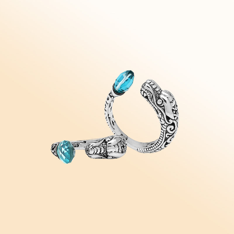 Handcrafted sterling silver dragon bypass ring with sparkling Blue Topaz Quartz, unique Bali artisan jewelry gift.