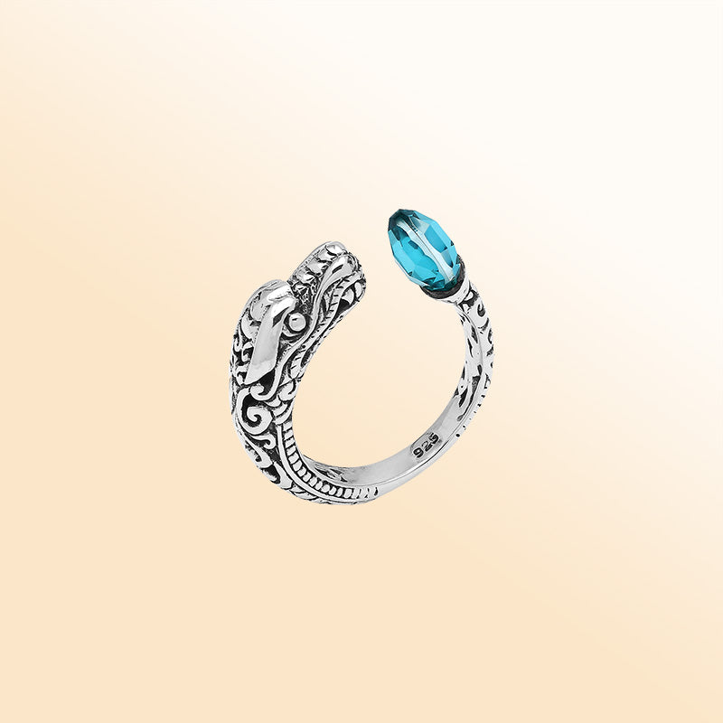 Handcrafted sterling silver dragon bypass ring with sparkling Blue Topaz Quartz, unique Bali artisan jewelry gift.