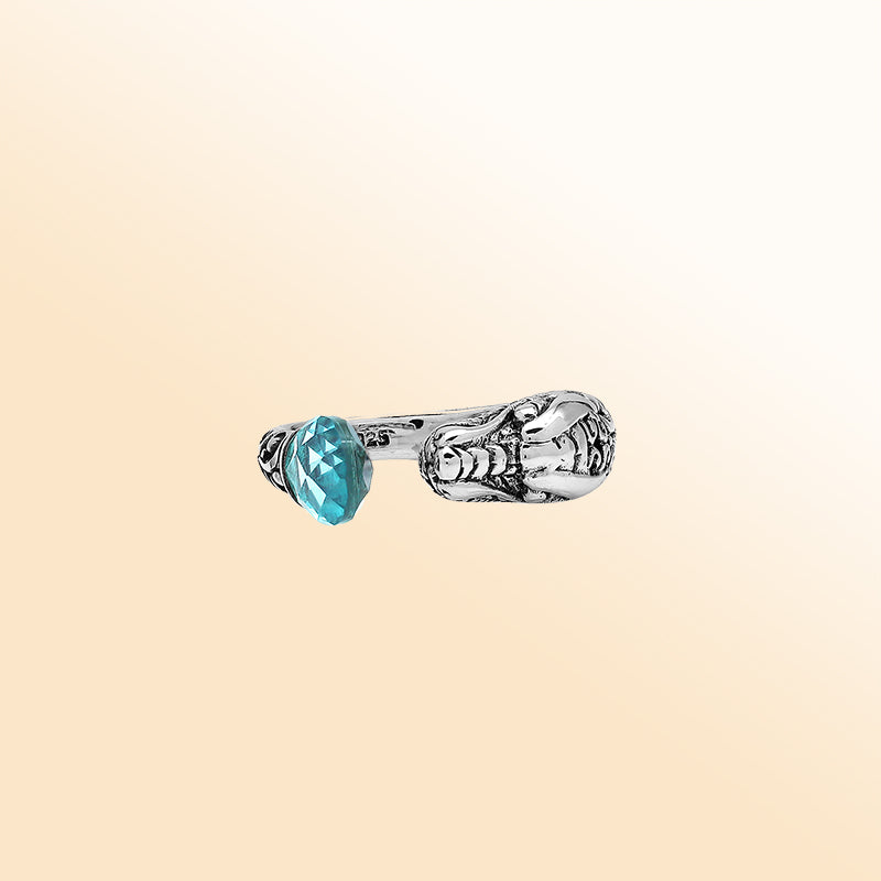 Handcrafted sterling silver dragon bypass ring with sparkling Blue Topaz Quartz, unique Bali artisan jewelry gift.