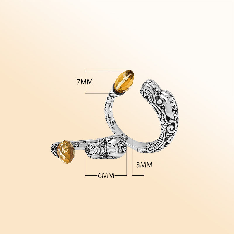 Sterling silver dragon ring with golden Citrine Quartz, handcrafted with Bali-inspired carvings, adjustable bypass design, and oxidized finish for a bold statement look.