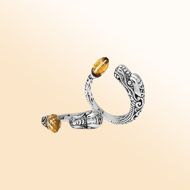 Sterling silver dragon ring with golden Citrine Quartz, handcrafted with Bali-inspired carvings, adjustable bypass design, and oxidized finish for a bold statement look.