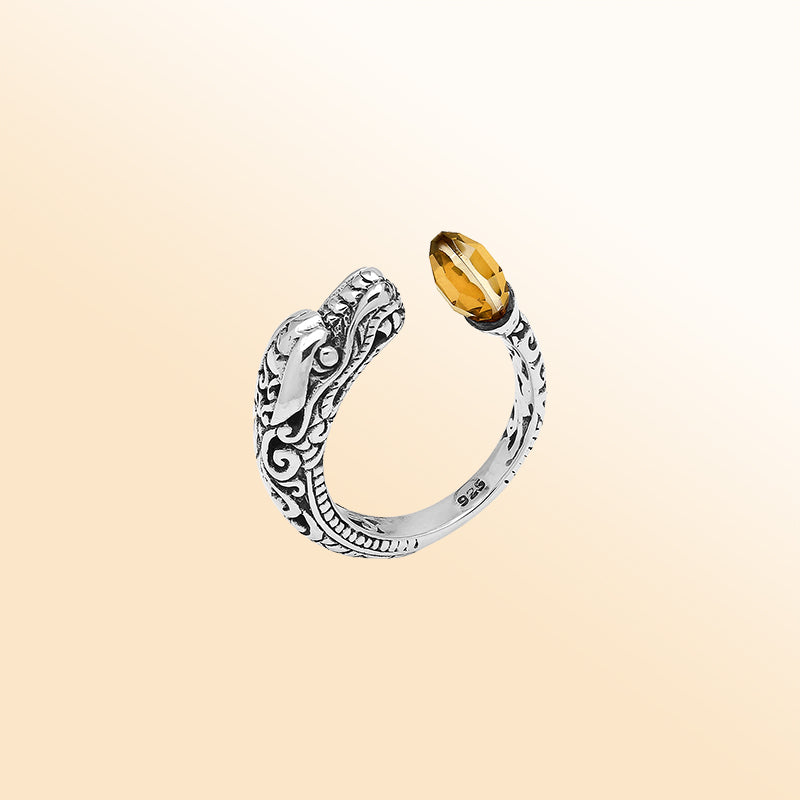 Sterling silver dragon ring with golden Citrine Quartz, handcrafted with Bali-inspired carvings, adjustable bypass design, and oxidized finish for a bold statement look.