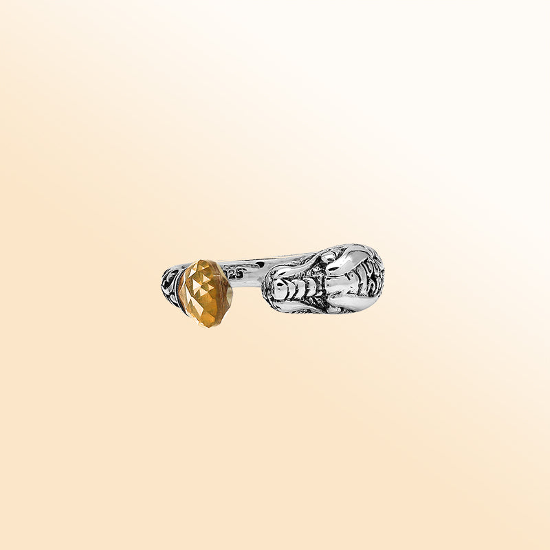 Sterling silver dragon ring with golden Citrine Quartz, handcrafted with Bali-inspired carvings, adjustable bypass design, and oxidized finish for a bold statement look.