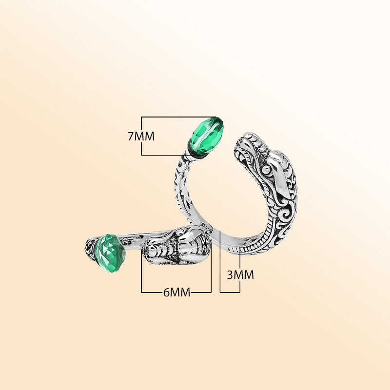 Handcrafted sterling silver dragon ring with Green Quartz accents, detailed Balinese carvings, and adjustable open band design for unique artisan style.