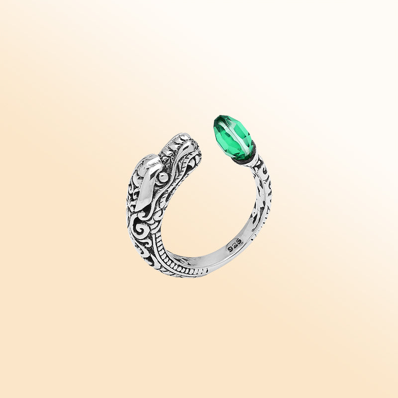 Handcrafted sterling silver dragon ring with Green Quartz accents, detailed Balinese carvings, and adjustable open band design for unique artisan style.