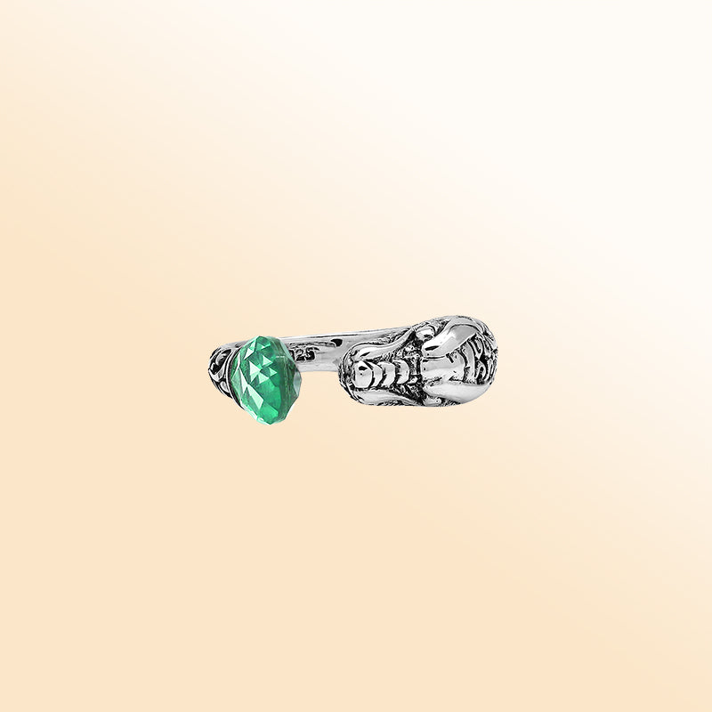 Handcrafted sterling silver dragon ring with Green Quartz accents, detailed Balinese carvings, and adjustable open band design for unique artisan style.