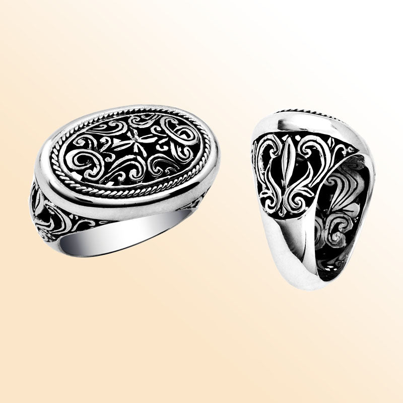 Woman sterling silver oval ring with intricate Bali carving and oxidized details, handcrafted 925 silver statement jewelry.