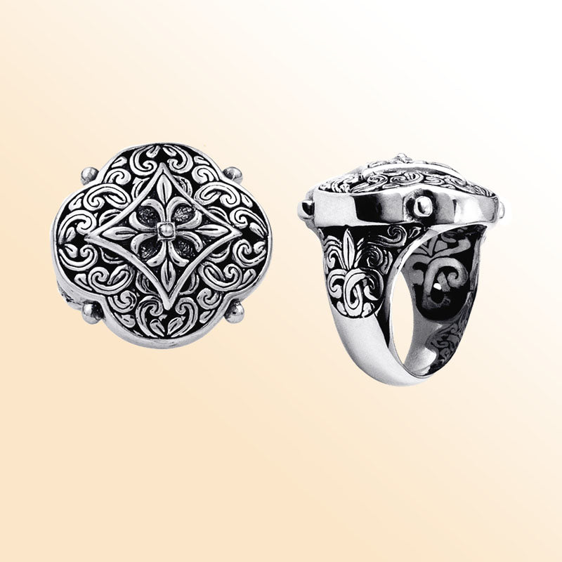 Handcrafted sterling silver Balinese statement ring with ornate floral medallion, detailed scrollwork, and oxidized finish for a bold artisan look.