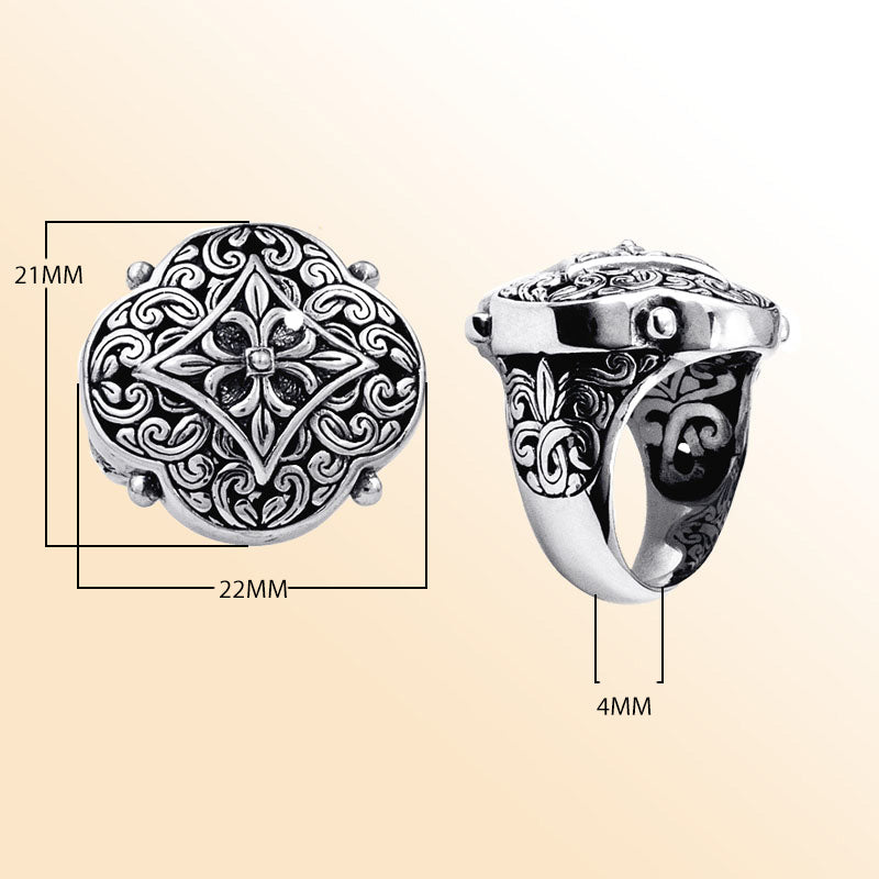 Handcrafted sterling silver Balinese statement ring with ornate floral medallion, detailed scrollwork, and oxidized finish for a bold artisan look.