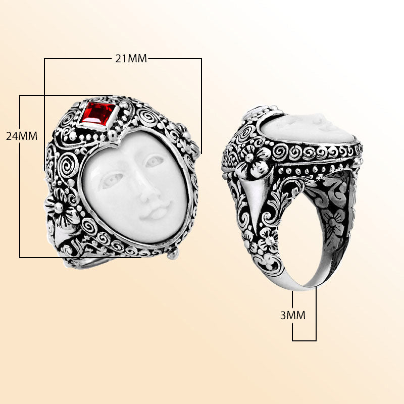 Handcrafted sterling silver ring with carved Bone Face, Garnet Quartz, and detailed Balinese floral design, unique artisan statement jewelry.