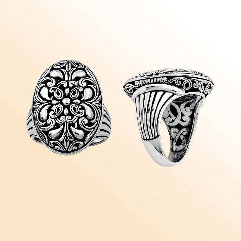 Handcrafted sterling silver oval floral ring with Balinese scroll detailing and oxidized finish, elegant artisan statement jewelry.