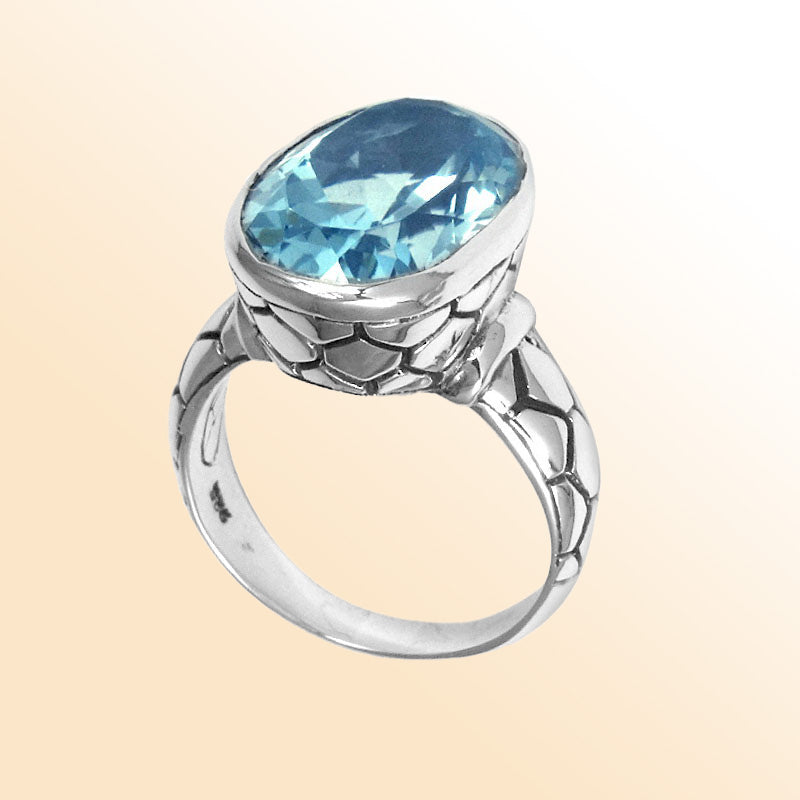 Handcrafted sterling silver ring with oval Blue Topaz Quartz and artisan carved band, made in Bali