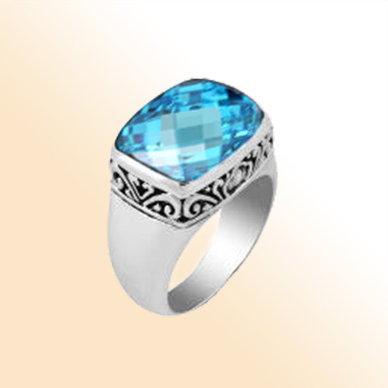 Sterling silver ring with a sparkling cushion-cut blue topaz  Quartz and delicate Balinese scroll details, handcrafted for a bold and elegant look.