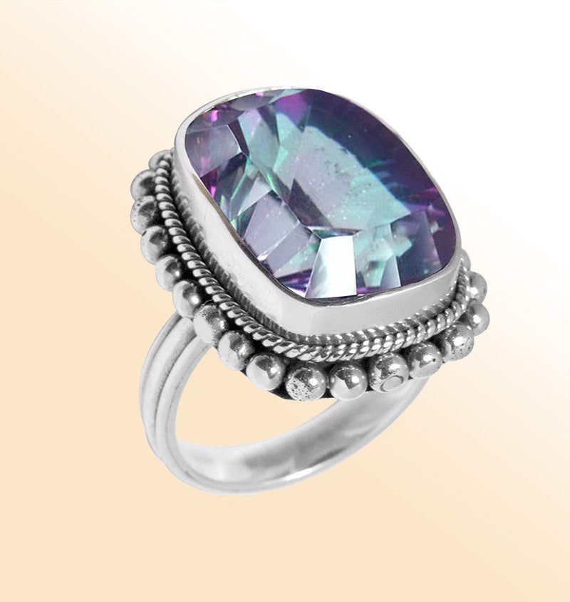 Sterling silver ring with faceted Mystic Topaz in purple, green, and blue hues – handcrafted Balinese statement jewelry.
