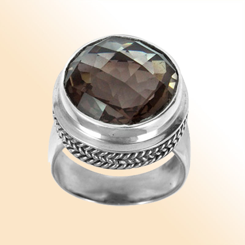 Sterling silver ring with a faceted smoky quartz and braided bezel detail, handcrafted in Bali for a bold artisan look.