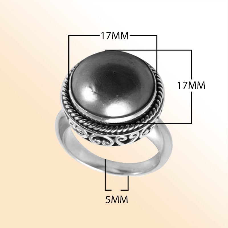 Sterling silver Grey Mabe Pearl ring with polished cabochon stone, twisted rope bezel, and artisan scrollwork, handcrafted in Bali.