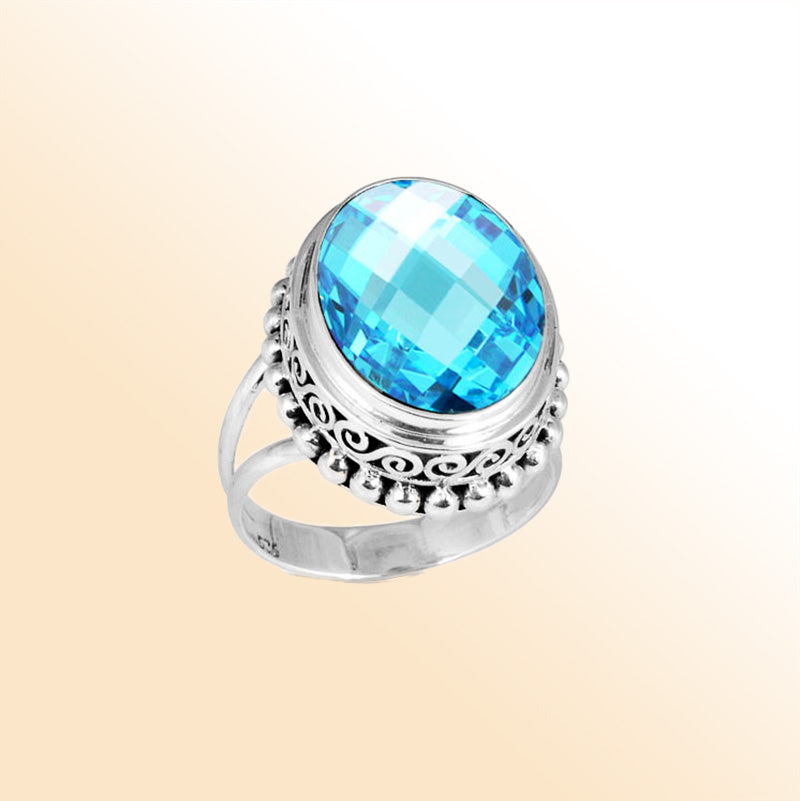 Sterling silver ring with faceted oval Blue Topaz Quartz, Balinese scroll and bead details – handcrafted artisan cocktail jewelry.
