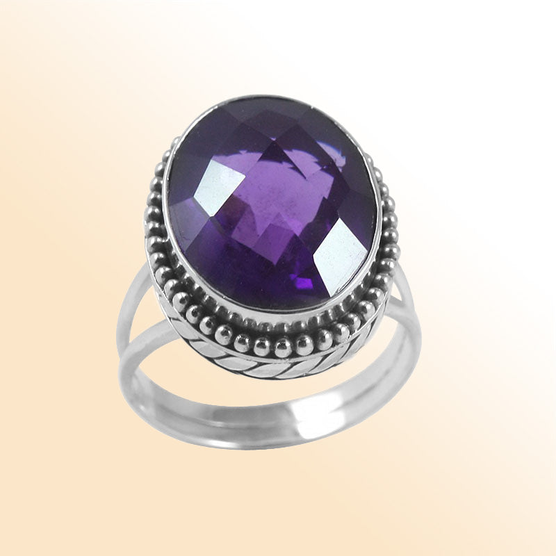 Sterling silver ring with faceted oval Amethyst Quartz and Balinese beaded details – handcrafted artisan cocktail jewelry.