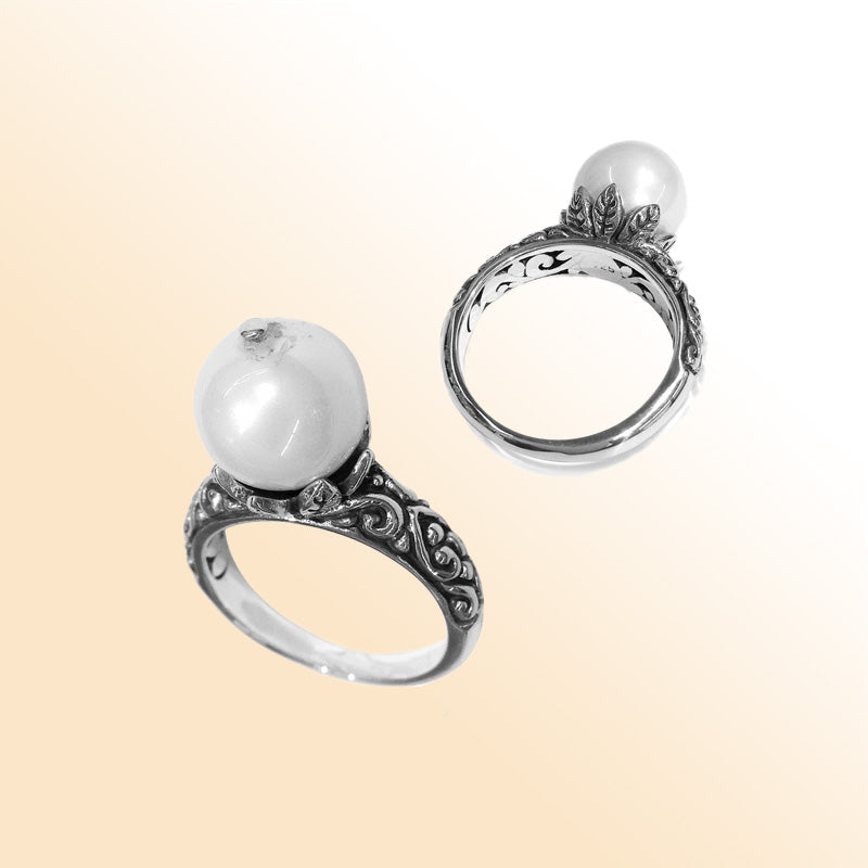 Elegant Balinese silver ring with white freshwater pearl and artisan scroll design.