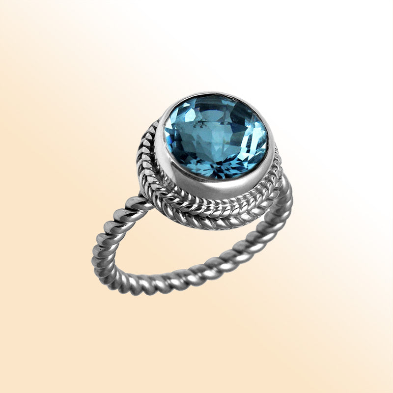 Handcrafted Bali silver ring with round Blue Topaz Quartz and rope-style band.
