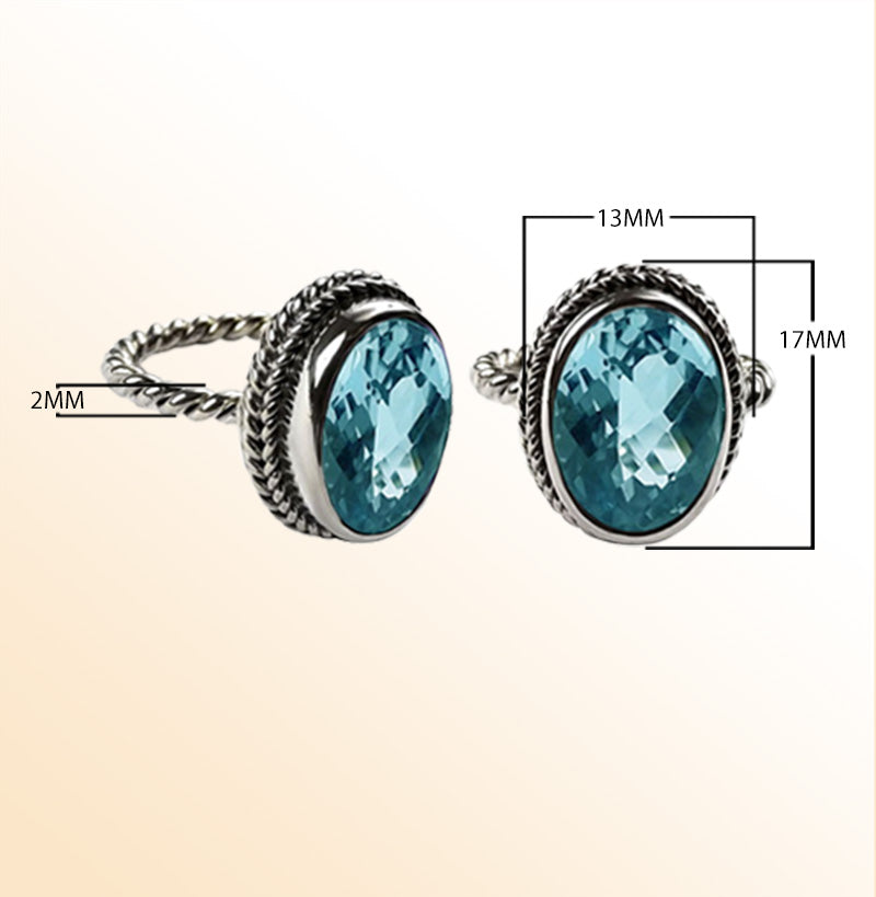 Handcrafted Bali silver ring with oval Blue Topaz Quartz and rope-style band.