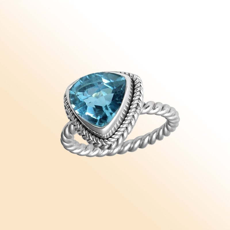 Handcrafted sterling silver Blue Topaz Quartz ring with faceted trillion-cut Quartz and rope bezel, artisan jewelry from Indonesia.