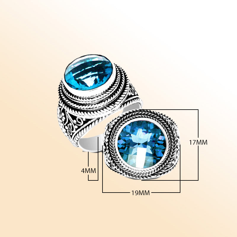 Handcrafted sterling silver Bali ring with round Blue Topaz Quartz and detailed rope scrollwork.