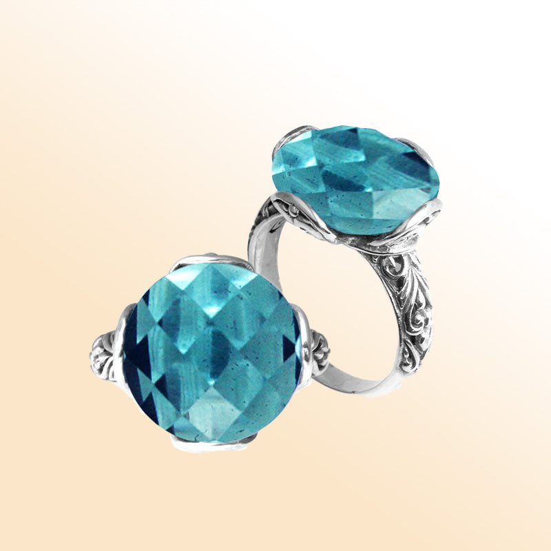 Handcrafted Bali sterling silver ring with faceted round Blue Topaz Quartz and scroll-carved band.