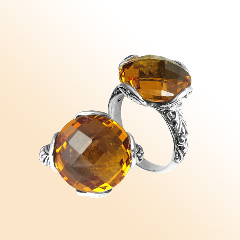 Handcrafted sterling silver Bali ring with faceted round Citrine Quartz and scroll-carved band.