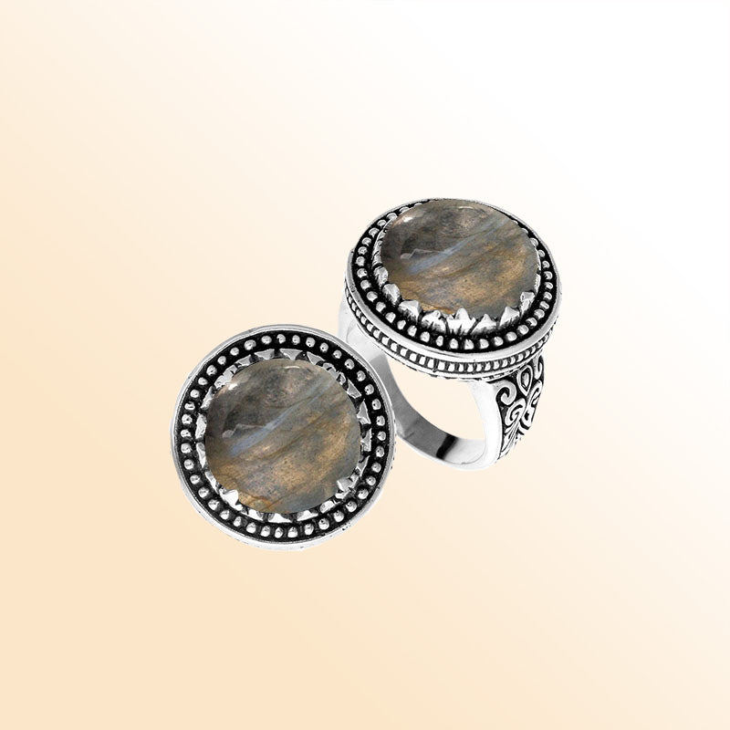 Handcrafted sterling silver Bali ring with Labradorite cabochon and beaded halo design.