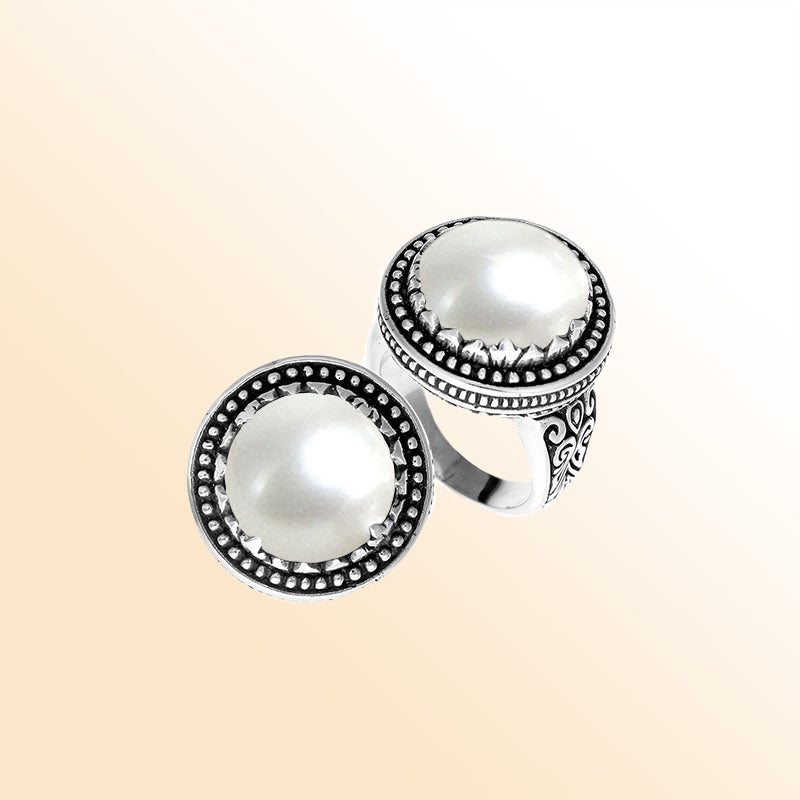 Handcrafted sterling silver Bali ring with Luminous Mother of Pearl cabochon and beaded halo.