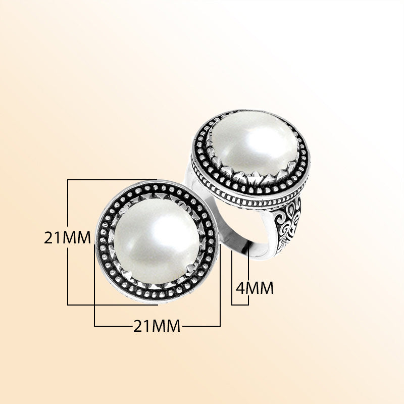 Handcrafted sterling silver Bali ring with Luminous Mother of Pearl cabochon and beaded halo.