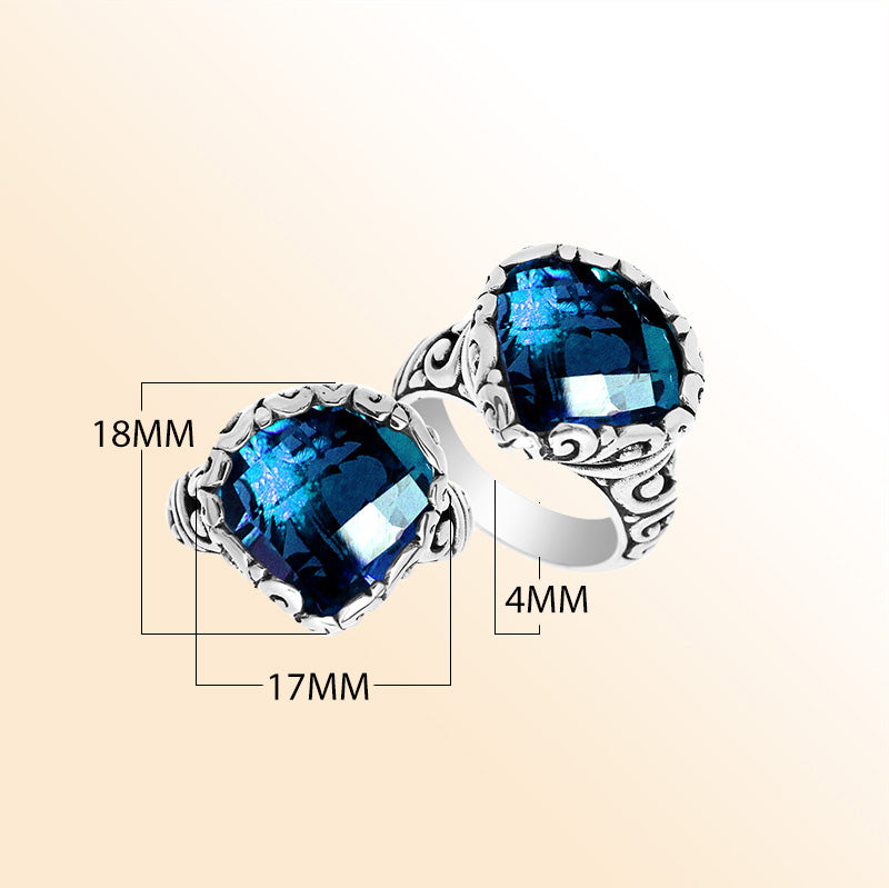 Handmade sterling silver Balinese ring with cushion-cut London Blue Topaz Quartz and scrollwork detailing.