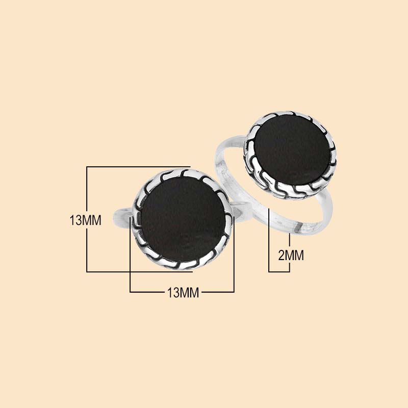 Bold sterling silver ring showcasing a round Black Shell centerpiece surrounded by sculpted oxidized silver detailing and a sleek polished band.